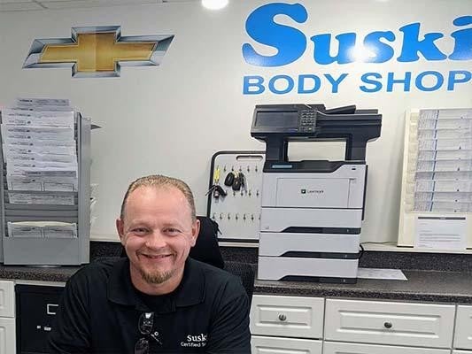 Body Shop employee working at desk