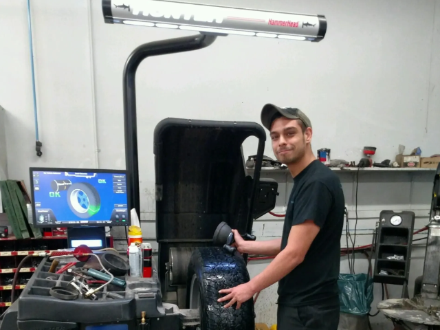 Technician working on a tire machine